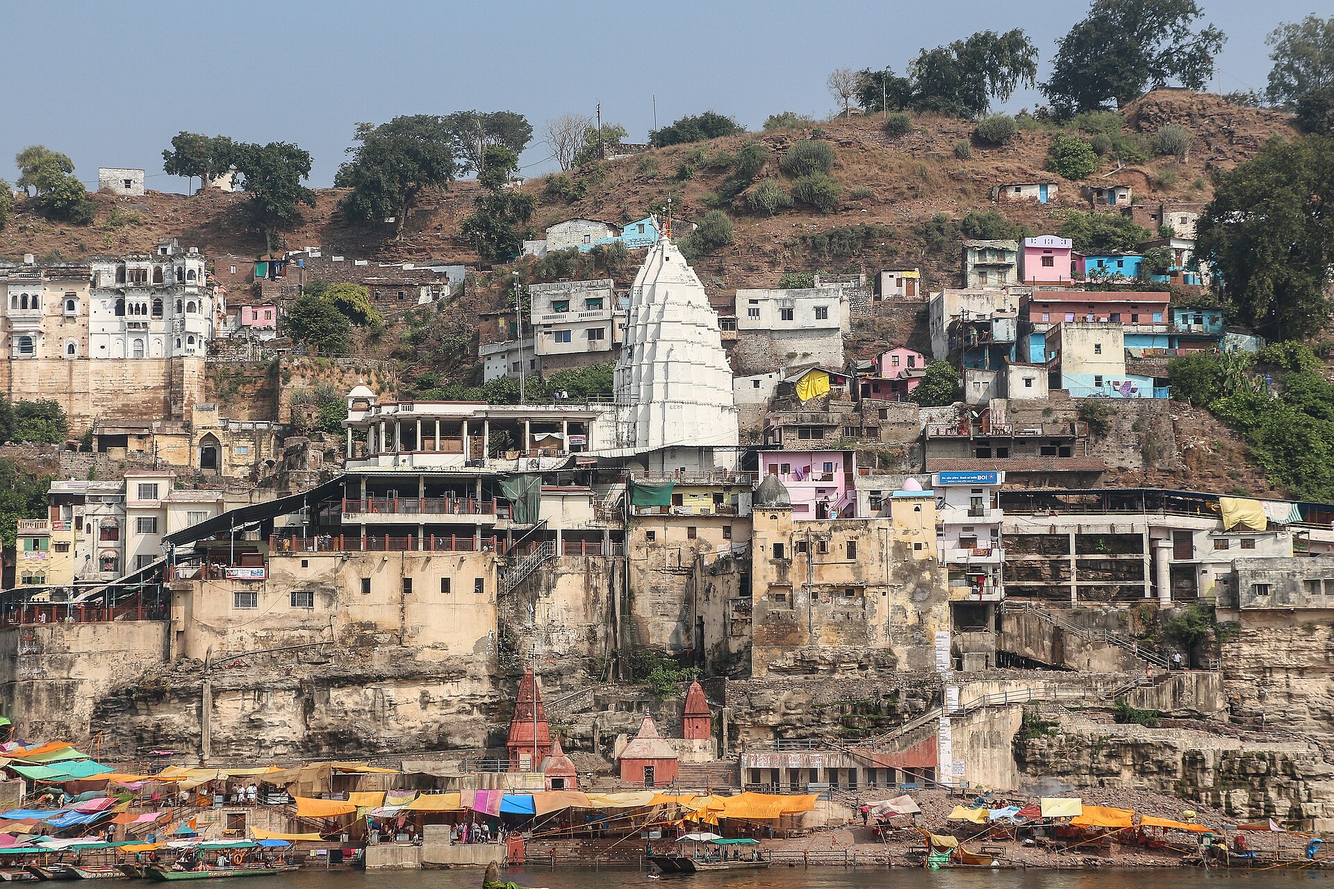 The Om-shaped Mandhata island at Omkareshwar seen from the riverbank with the Narmada surrounding it